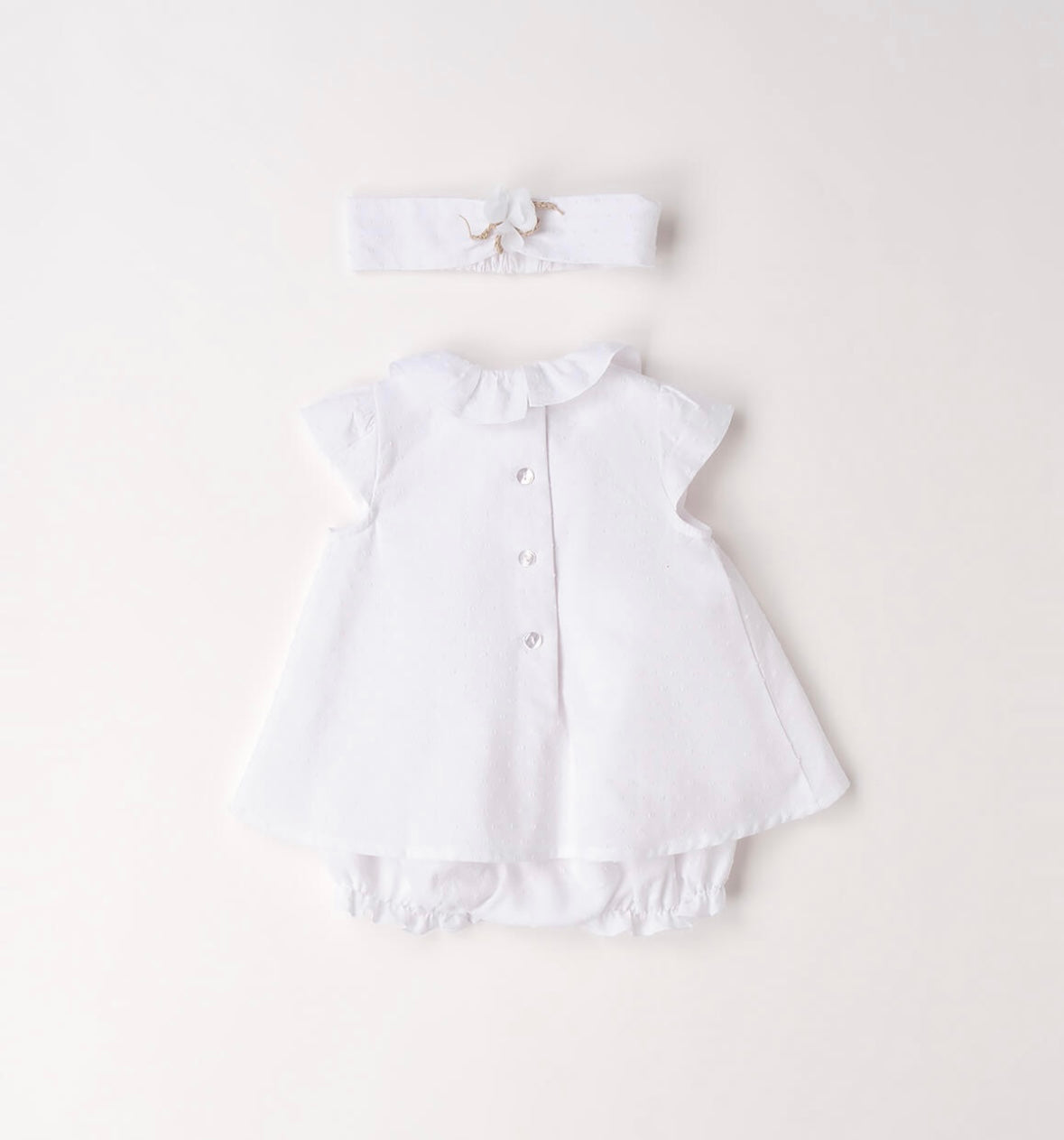 Pagliaccetto neonata in cotone bianco con fascia per capelli