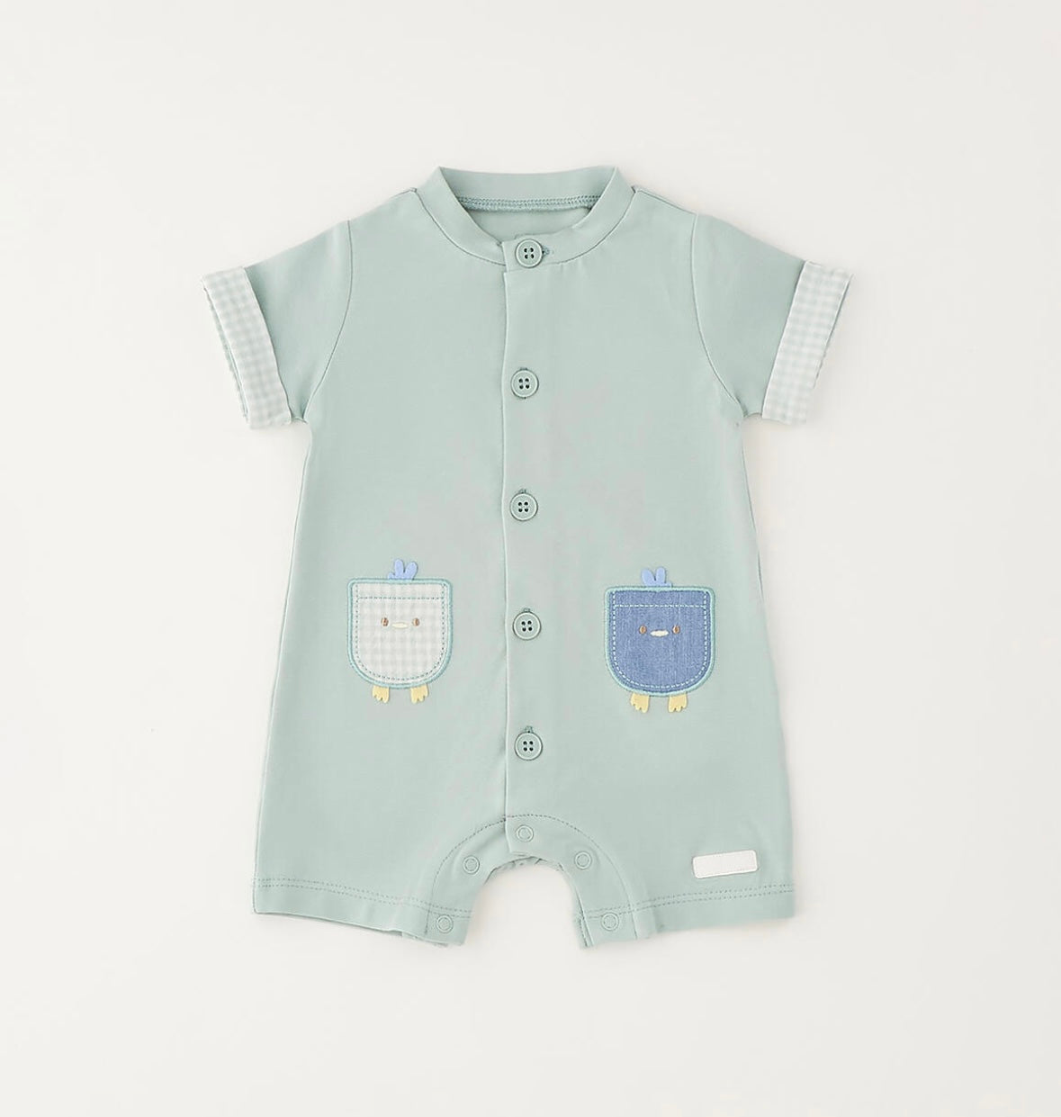 Pagliaccetto da neonato verde con applicazioni davanti