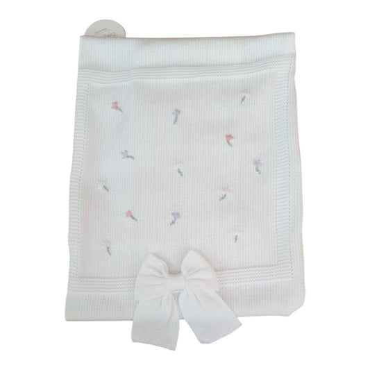 Coperta in cotone, di colore bianco con fiori colorati.